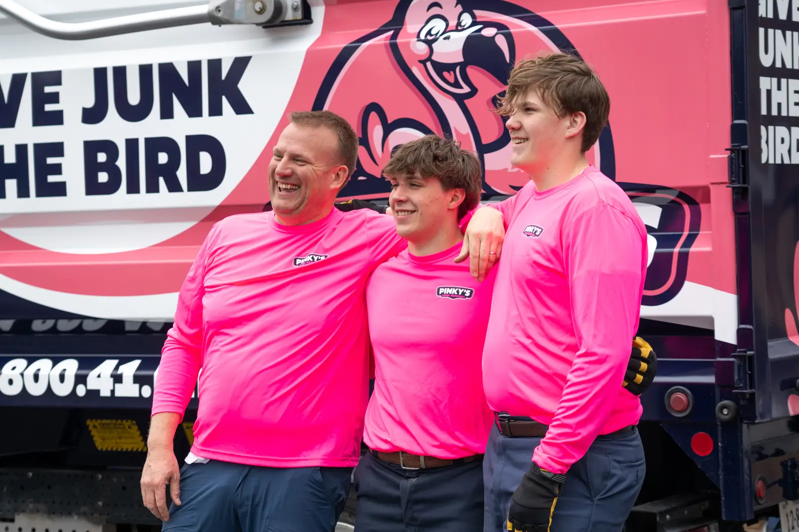 Team in pink uniforms – professional junk removal and cleanup crew