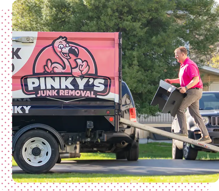 Pinky’s Junk Removal truck loading items – professional hauling service